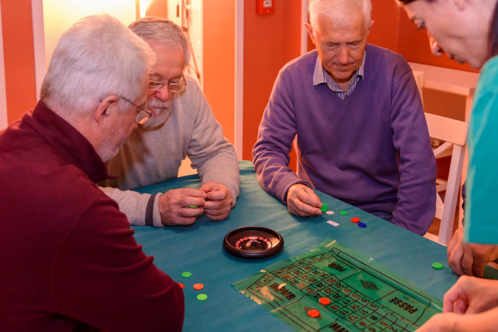 Three men playing a board game on the table.